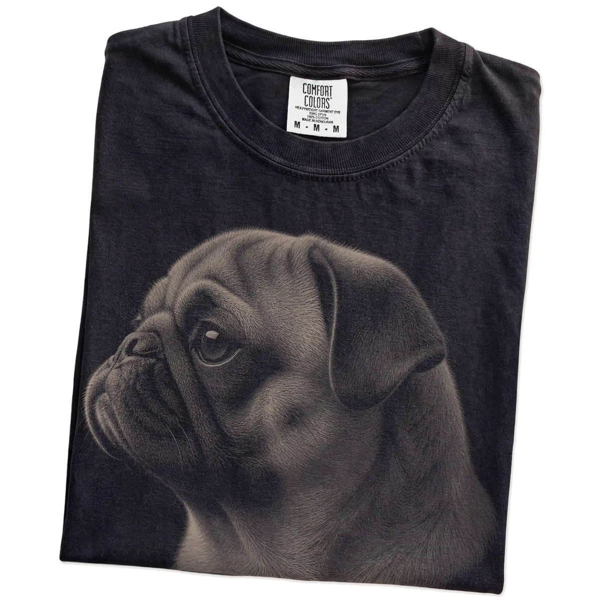 Folded Black Comfort Colors® T-shirt showing a detailed photographic portrait of a Pug
