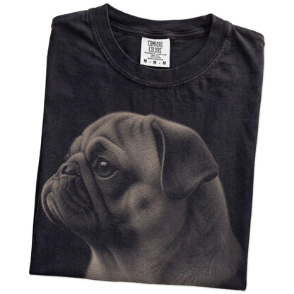 Folded Black Comfort Colors® T-shirt showing a detailed photographic portrait of a Pug