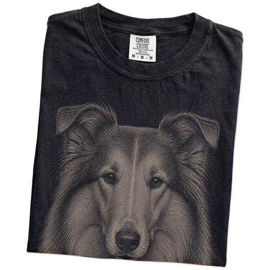 Folded Black Comfort Colors® T-shirt showing a realistic drawing of a Collie