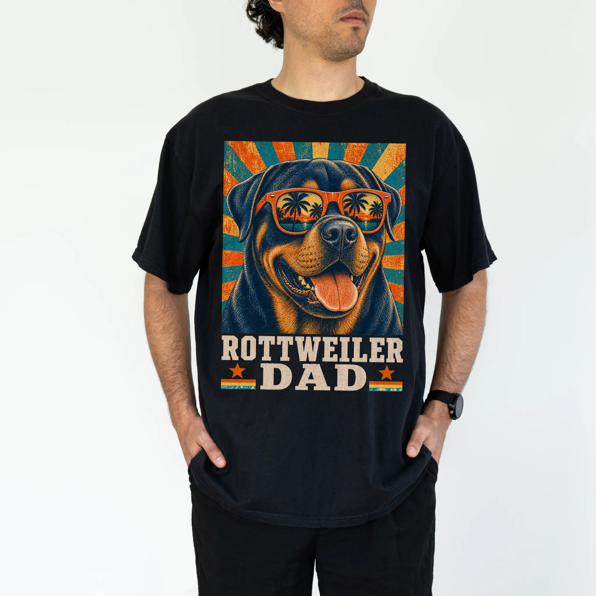 Retro Rottweiler Dad design on a Black Comfort Colors T-shirt worn by a model