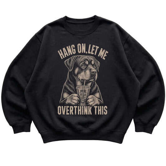 Black crewneck sweatshirt featuring Overthinking Rottweiler, laid-flat presentation