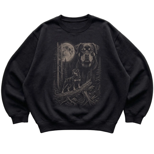 Rottweiler Moonlit Forest graphic on a black crewneck sweatshirt laid flat