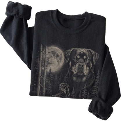 Folded black crewneck sweatshirt showing the Rottweiler Moonlit Forest graphic
