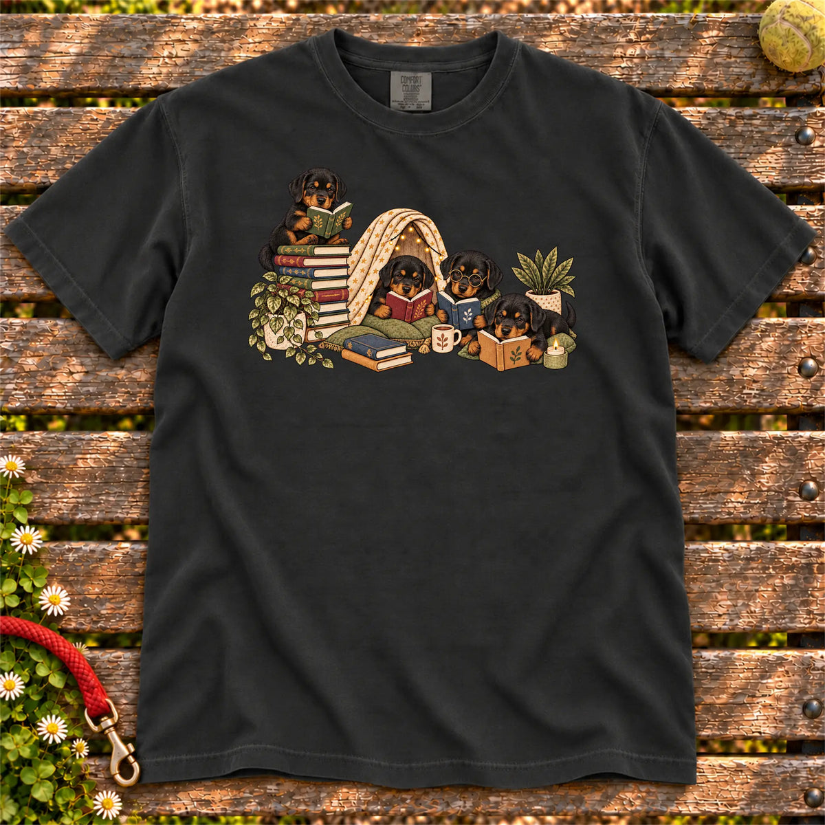 Rottweiler puppies reading books in a cozy blanket fort on a Black T-shirt