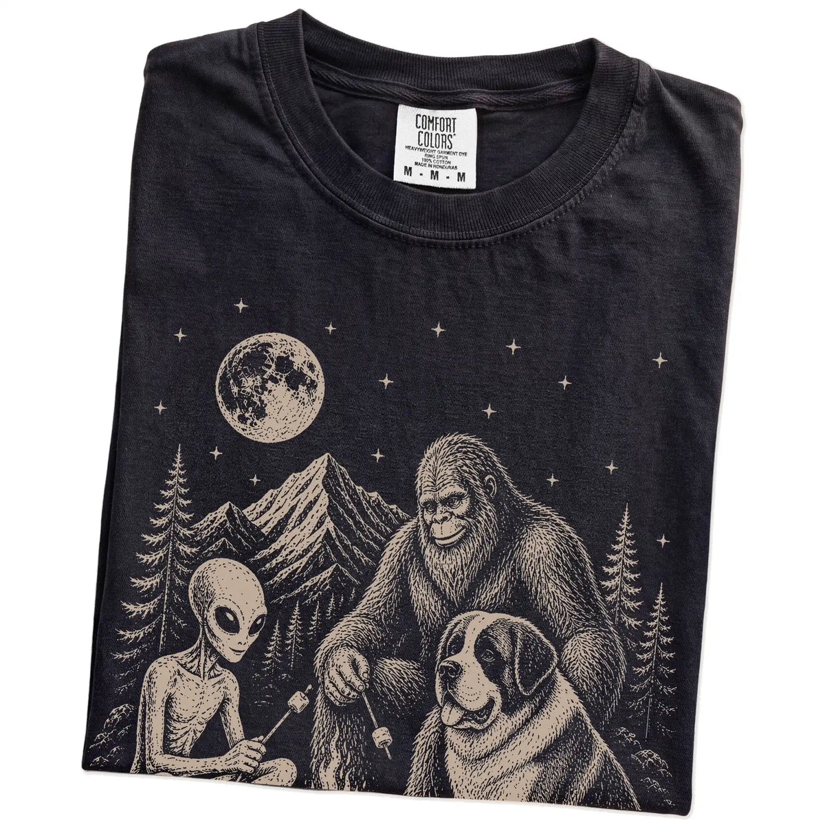 Folded Black Comfort Colors® T-shirt showing Saint Bernard camping with Bigfoot and an alien