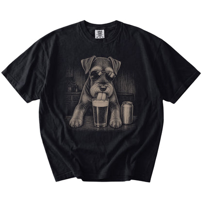 Schnauzer sneaking a drink from a foamy pint at home on a Black Comfort Colors® t-shirt