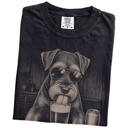 Folded Black Comfort Colors® t-shirt showing Schnauzer sneaking a drink from a pint