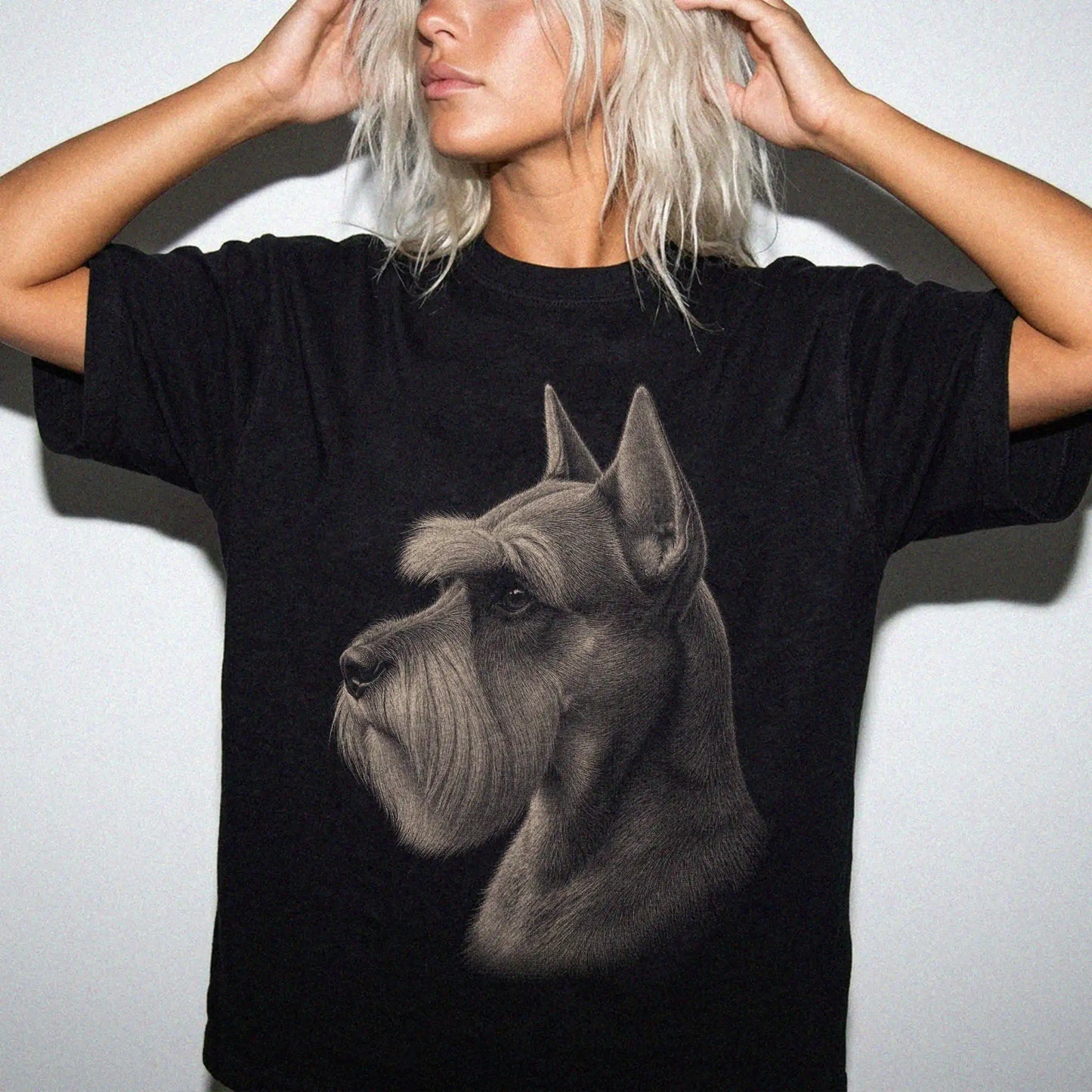 Model wearing a Black Comfort Colors® T-shirt with a detailed photographic portrait of a Schnauzer