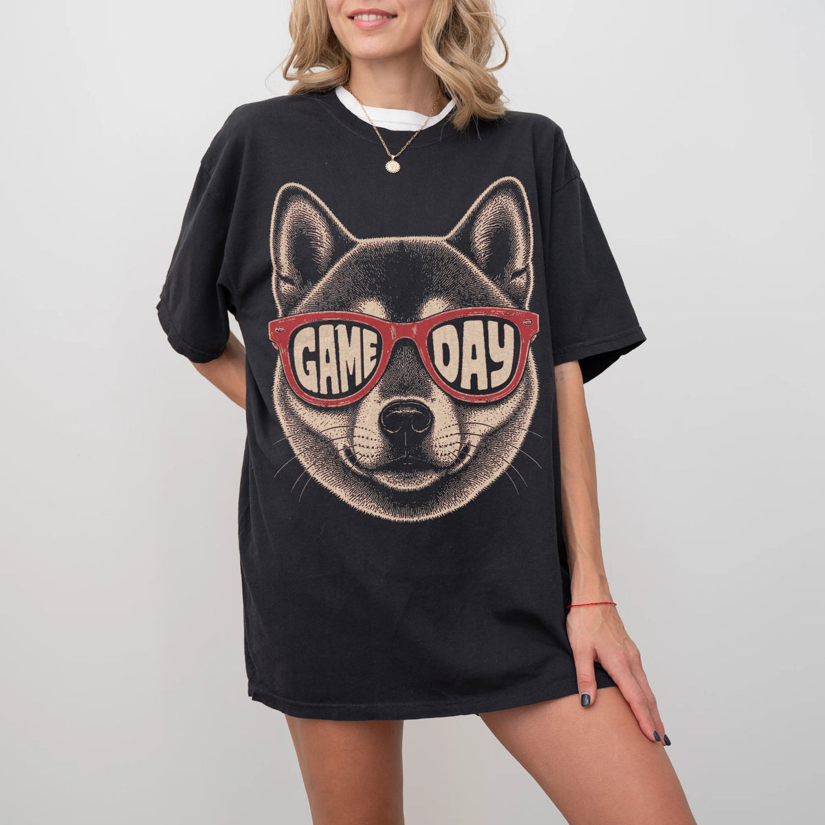 Model wearing a Black Comfort Colors® T-shirt with shiba inu wearing red game day sunglasses