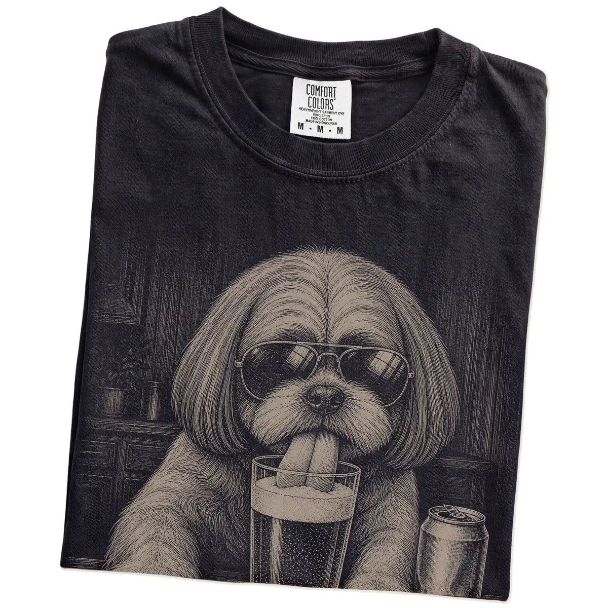 Folded Black Comfort Colors® t-shirt showing Shih Tzu sneaking a drink from a pint