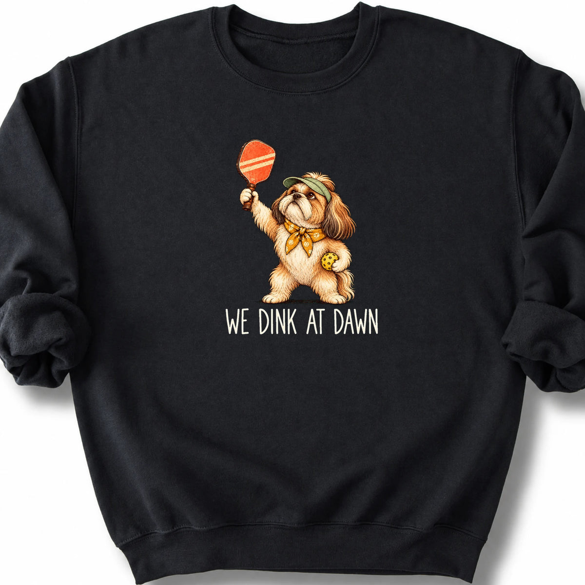 Shih Tzu with a pickleball paddle and ball on a Black Gildan® sweatshirt with We Dink at Dawn text