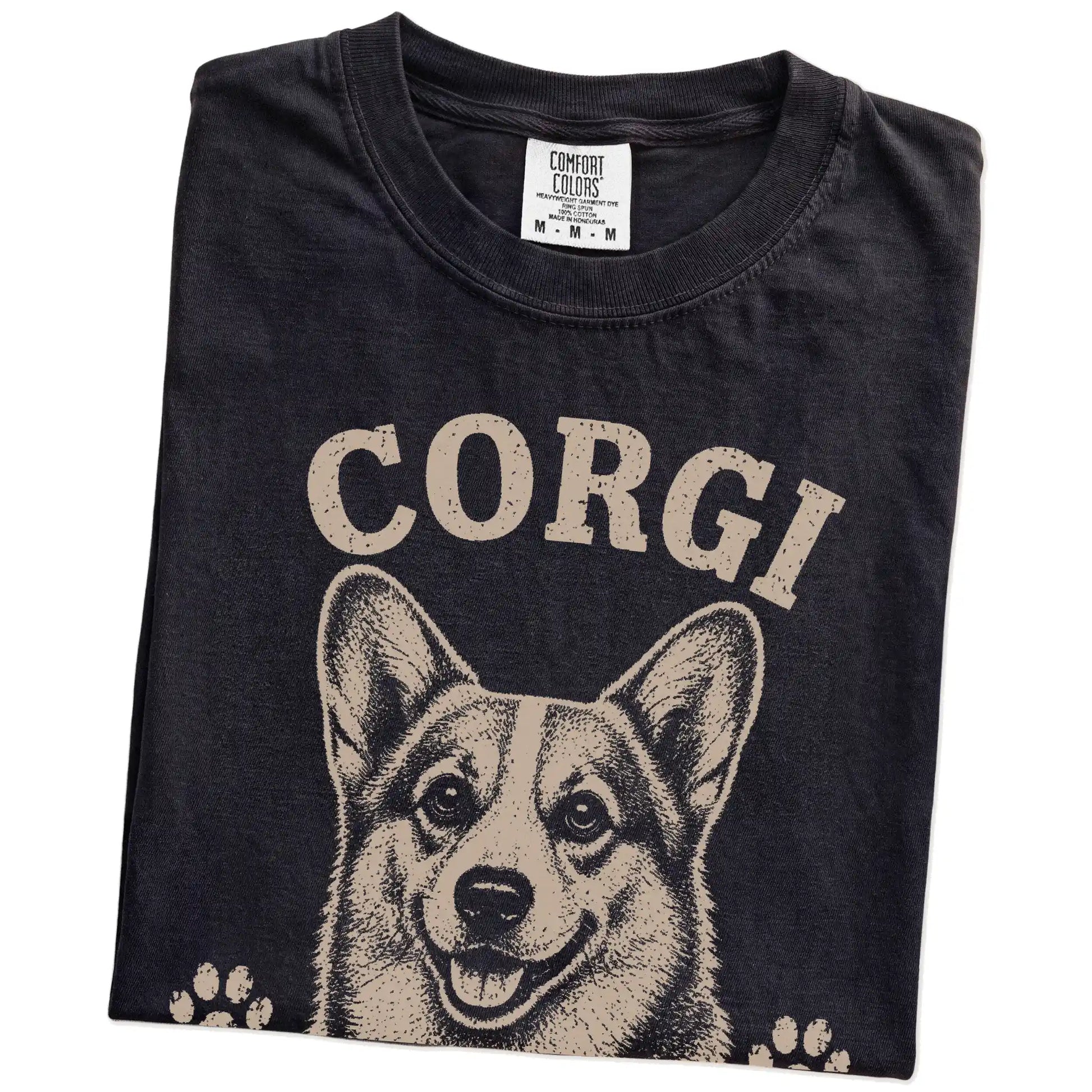 Folded Black Comfort Colors® T-shirt showing Corgi design with “Short Legs, Big Ambitions” lettering