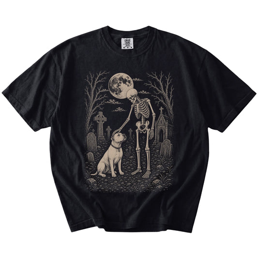 American Bulldog sharing a quiet cemetery moment with a friendly skeleton on a Black Comfort Colors® T-shirt