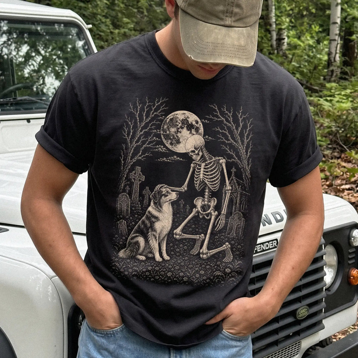 Model wearing a Black Comfort Colors® T-shirt showing Australian Shepherd sharing a quiet cemetery moment with a friendly ske