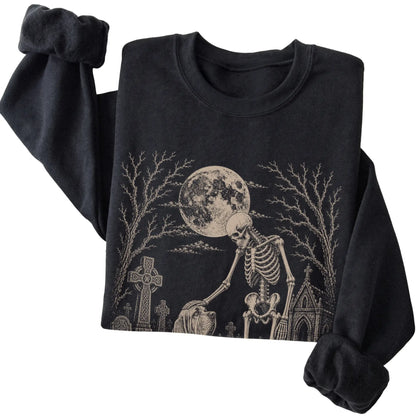 Folded Black sweatshirt with a skeleton petting a Bloodhound in a graveyard