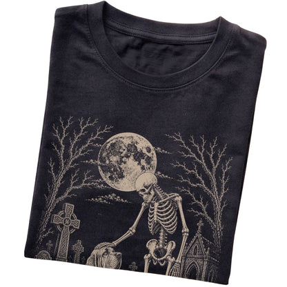 Folded Black T-shirt with a skeleton petting a Bloodhound in a graveyard