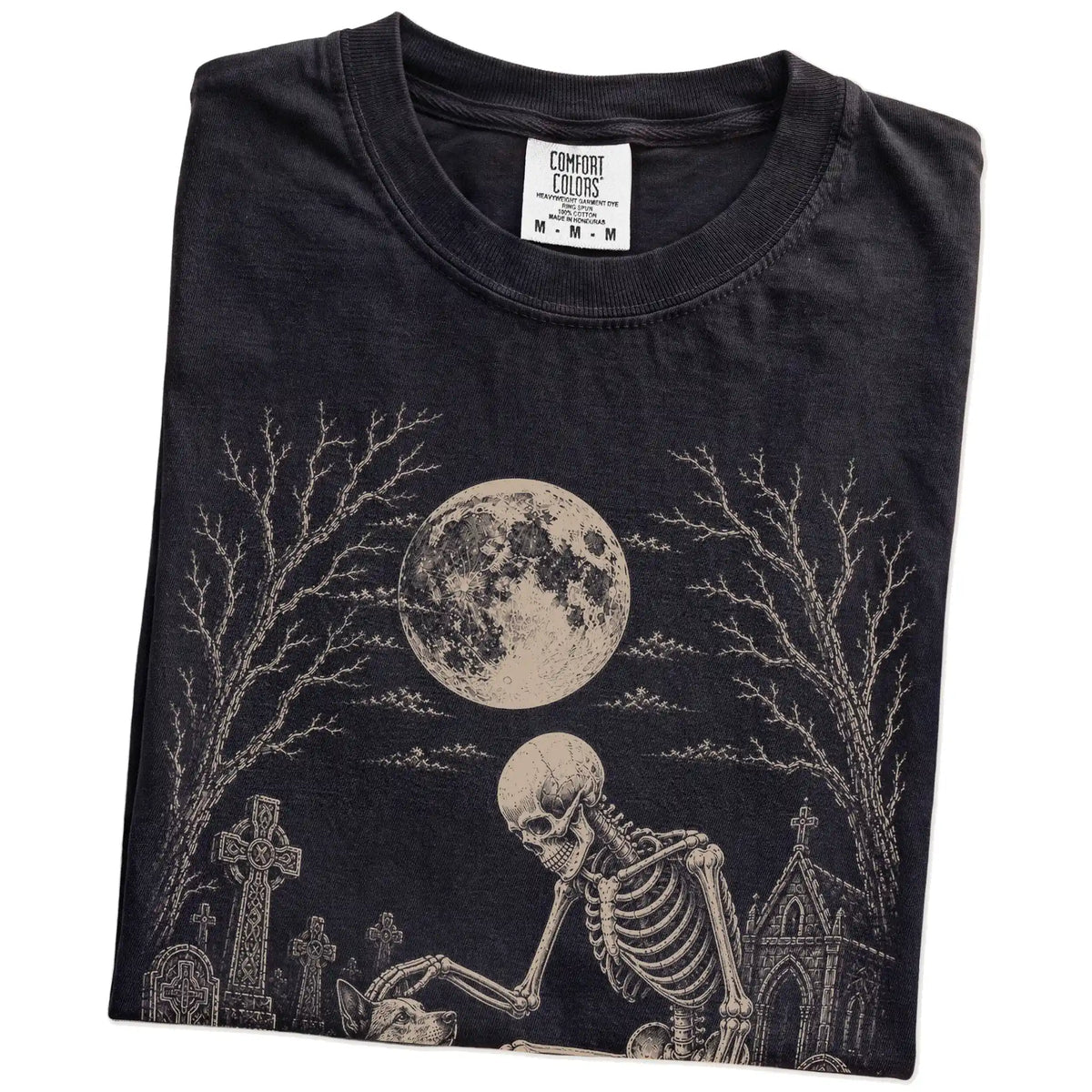 Folded Black Comfort Colors® T-shirt showing Blue Heeler sharing a quiet cemetery moment with a friendly skeleton