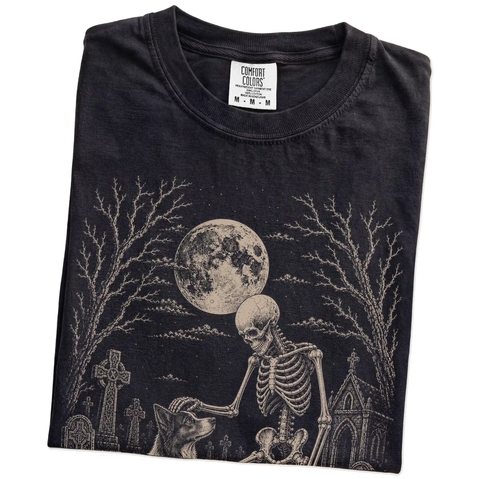 Folded Black Comfort Colors® T-shirt showing Border Collie sharing a quiet cemetery moment with a friendly skeleton