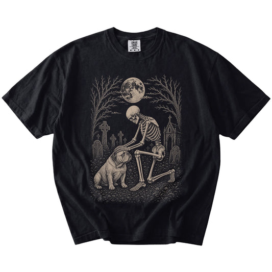Bulldog sharing a quiet cemetery moment with a friendly skeleton on a Black Comfort Colors® T-shirt