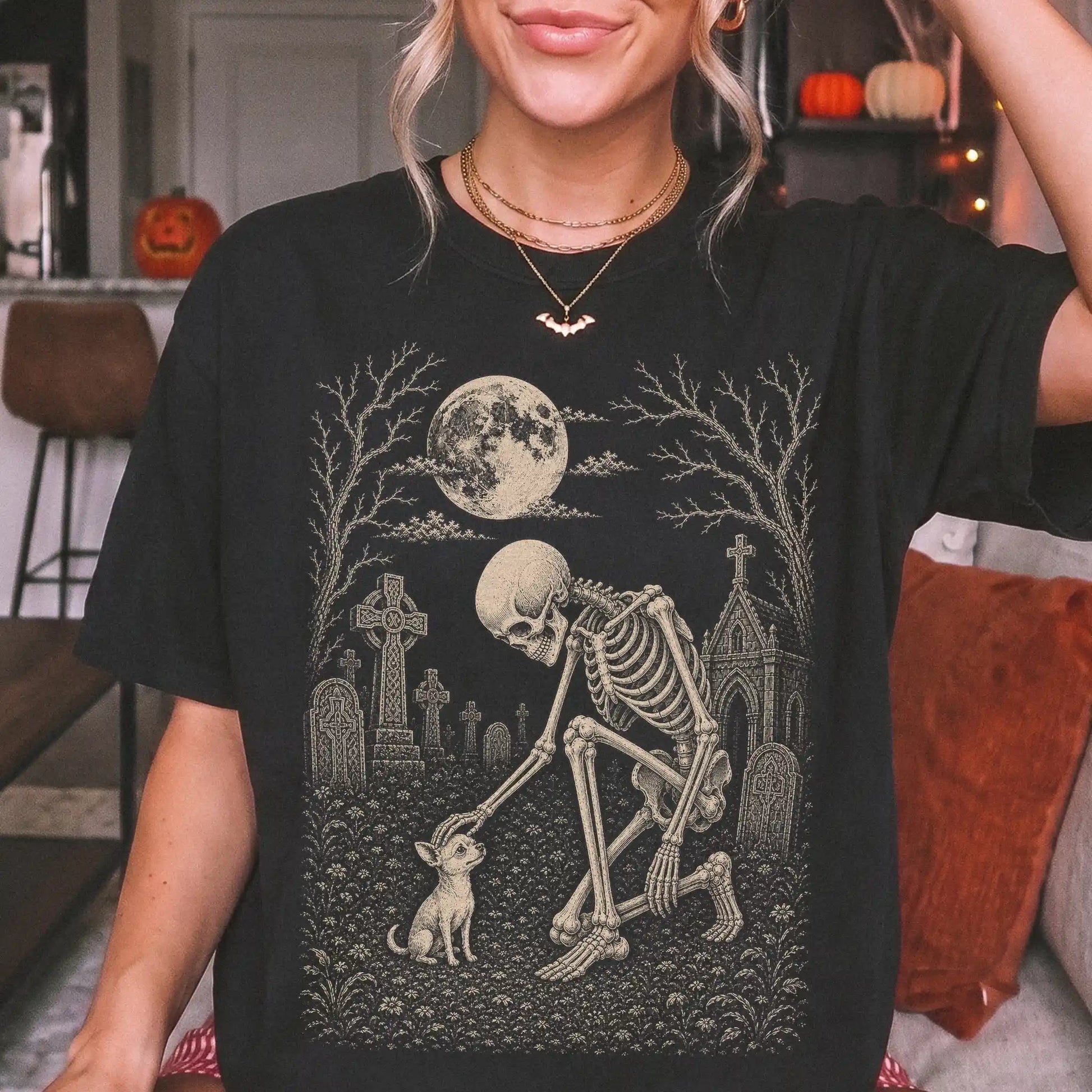 Model wearing a Black Comfort Colors® T-shirt showing Chihuahua sharing a quiet cemetery moment with a friendly skeleton