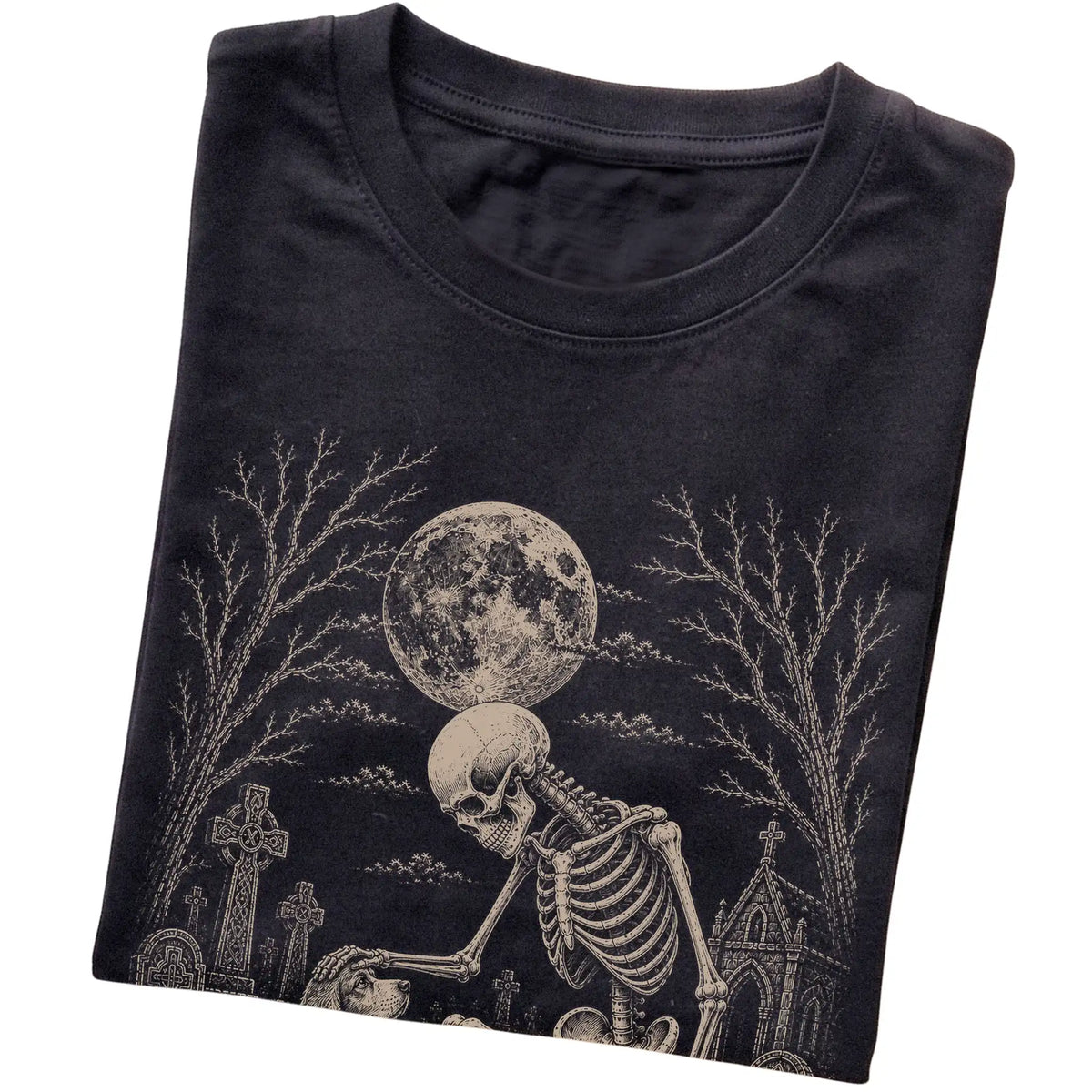 Folded Black T-shirt with a skeleton petting a Cocker Spaniel in a graveyard