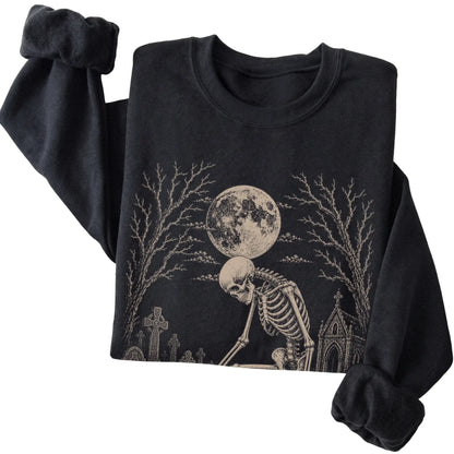 Folded Black sweatshirt with a skeleton petting a Corgi in a graveyard