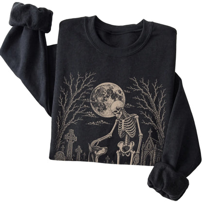 Folded Black sweatshirt with a skeleton petting a Doberman in a graveyard
