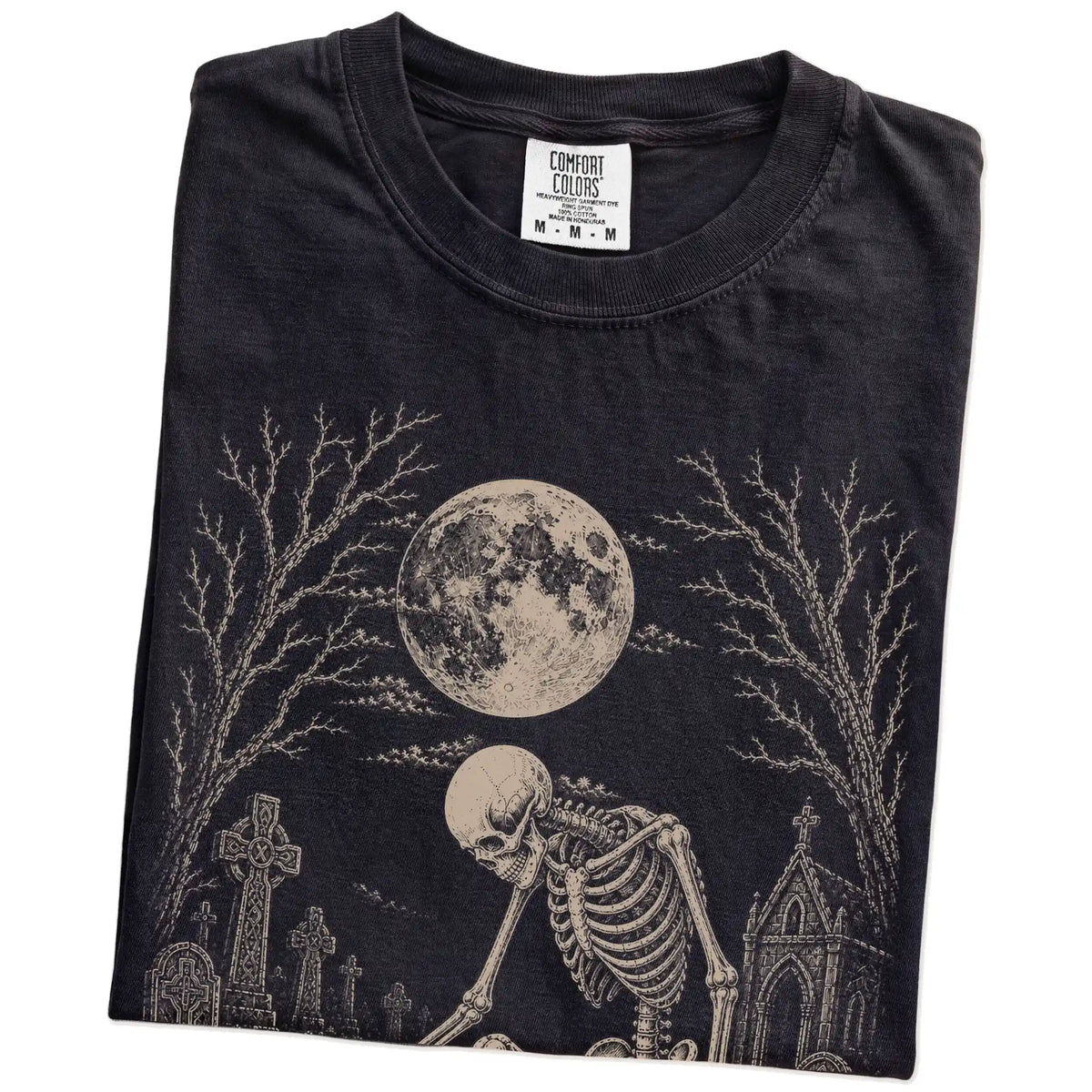 Folded Black Comfort Colors® T-shirt showing French Bulldog sharing a quiet cemetery moment with a friendly skeleton