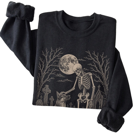 Folded Black sweatshirt with a skeleton petting a German Shepherd in a graveyard