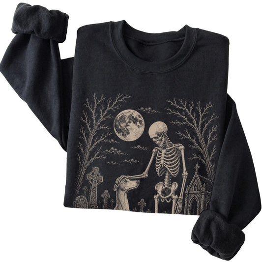 Folded Black sweatshirt with a skeleton petting a Greyhound in a graveyard