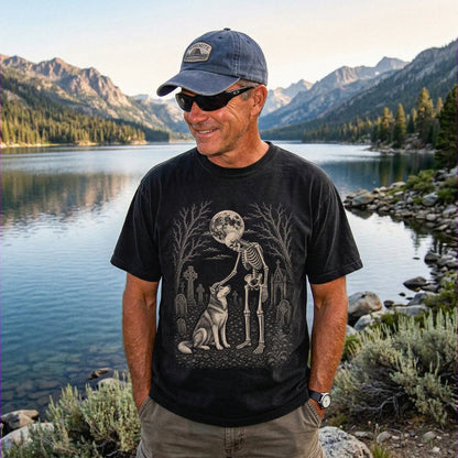 Model wearing a Black Comfort Colors® T-shirt showing Husky sharing a quiet cemetery moment with a friendly skeleton