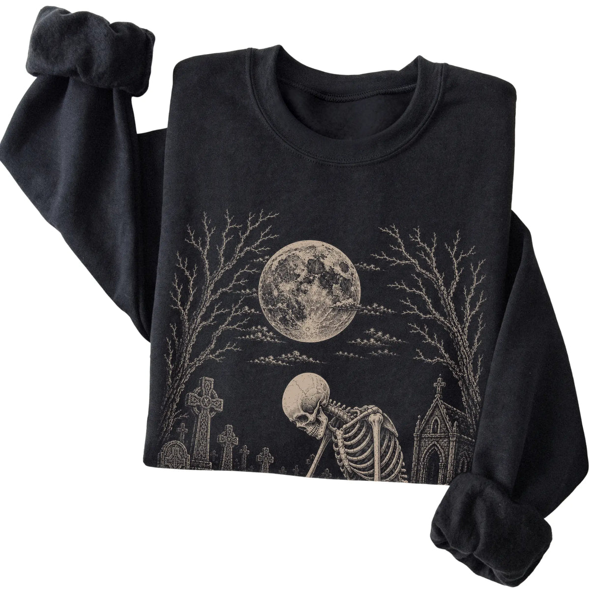 Folded Black sweatshirt with a skeleton petting a Maltese in a graveyard