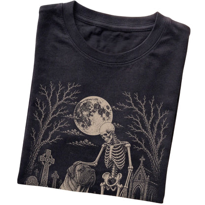 Folded Black T-shirt with a skeleton petting a Mastiff in a graveyard