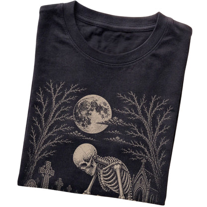 Folded Black T-shirt with a skeleton petting a Pug in a graveyard