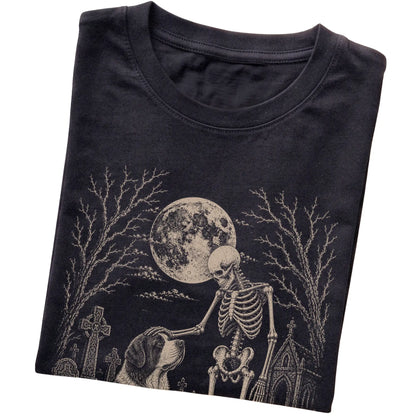Folded Black T-shirt with a skeleton petting a Saint Bernard in a graveyard