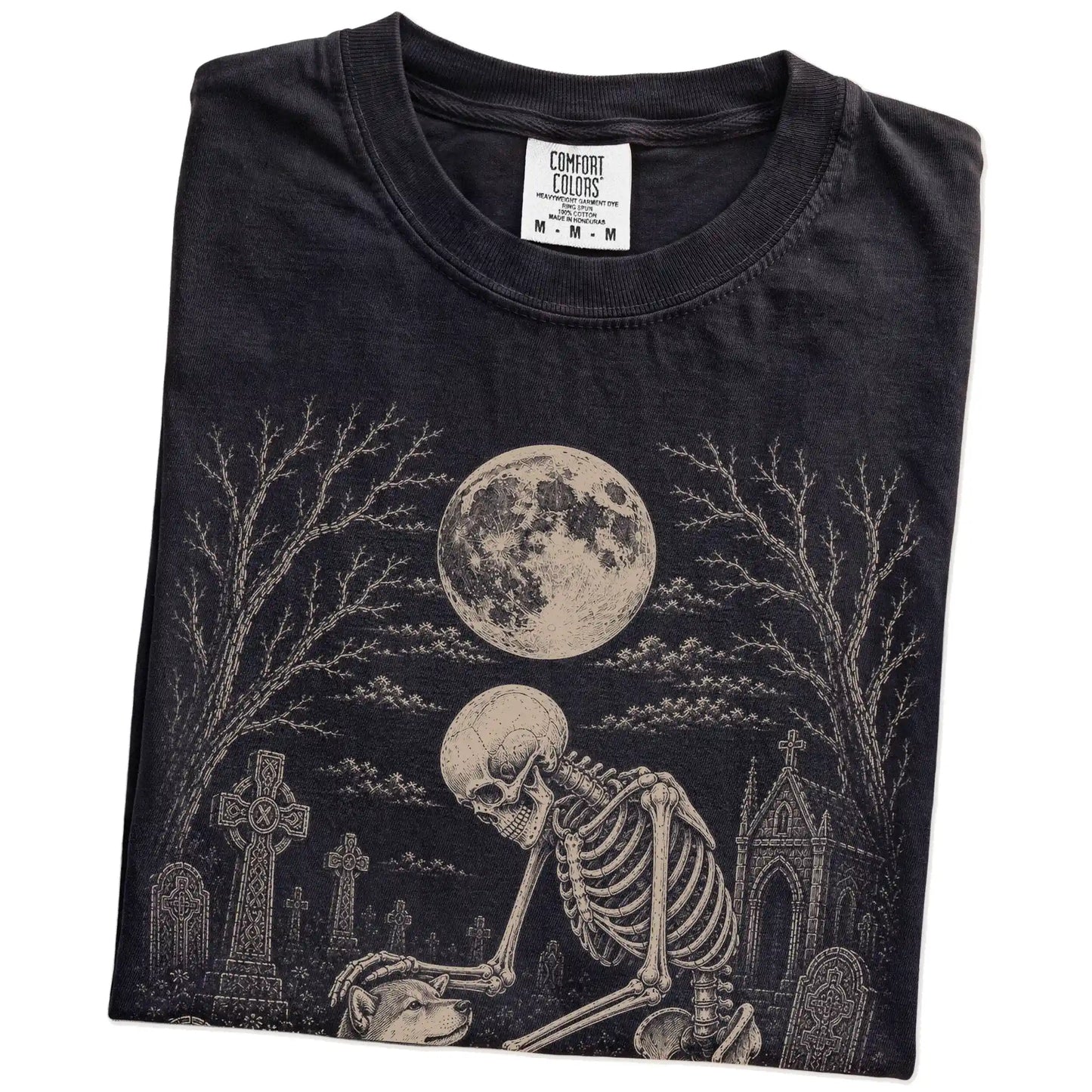 Folded Black Comfort Colors® T-shirt showing Shiba Inu sharing a quiet cemetery moment with a friendly skeleton