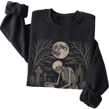 Folded Black sweatshirt with a skeleton petting a Shiba Inu in a graveyard