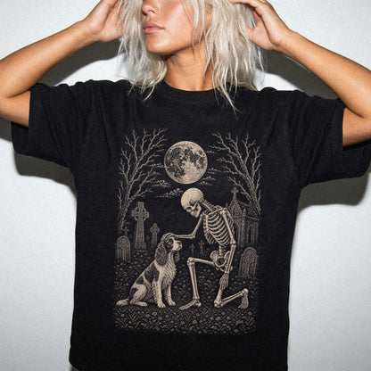 Model wearing a Black Comfort Colors® T-shirt showing Springer Spaniel sharing a quiet cemetery moment with a friendly skelet