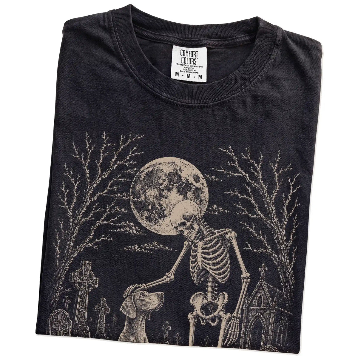 Folded Black Comfort Colors® T-shirt showing Weimaraner sharing a quiet cemetery moment with a friendly skeleton