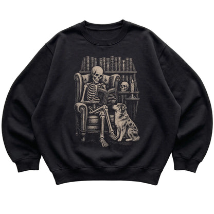 Skeleton reading Tales Beyond to an Australian Shepherd on a Black sweatshirt