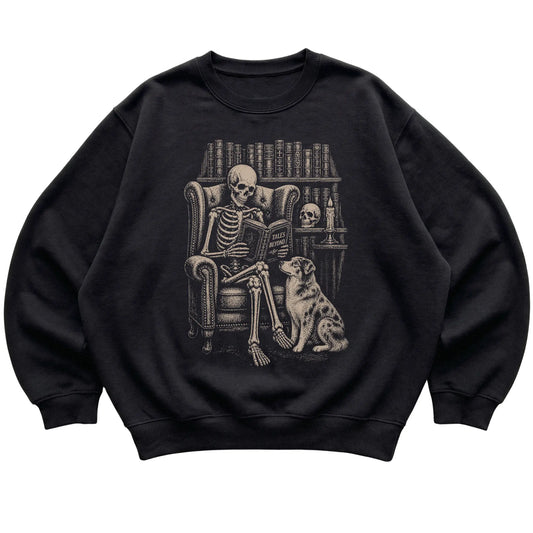 Skeleton reading Tales Beyond to an Australian Shepherd on a Black sweatshirt