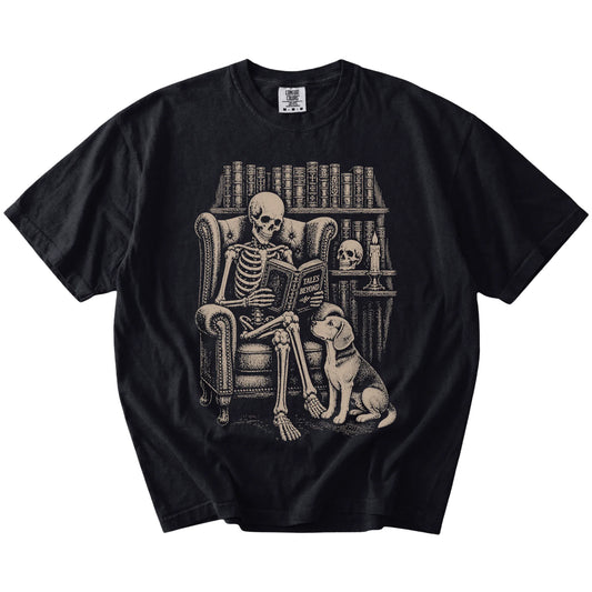Skeleton reading in a library beside a Beagle on a Black Comfort Colors® T-shirt
