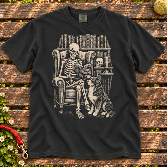 Skeleton reading in a library beside a Bernese Mountain Dog on a Black Comfort Colors® T-shirt