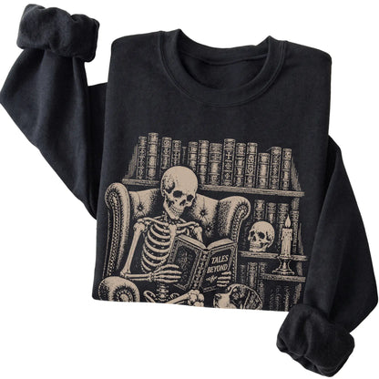 Folded Black sweatshirt with a skeleton reading Tales Beyond to a Bernese Mountain Dog