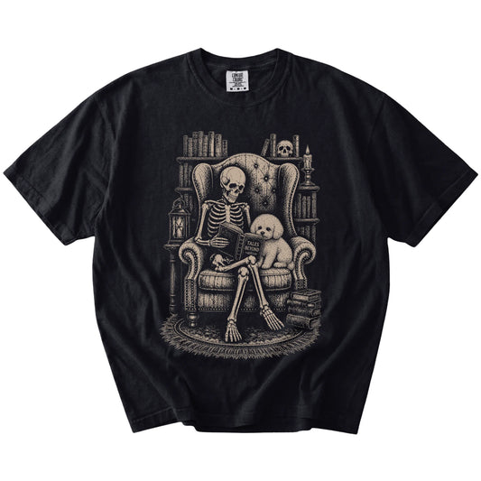 Skeleton reading in a library beside a Bichon Frise on a Black Comfort Colors® T-shirt