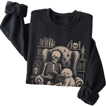 Folded Black sweatshirt with a skeleton reading Tales Beyond to a Bichon Frise