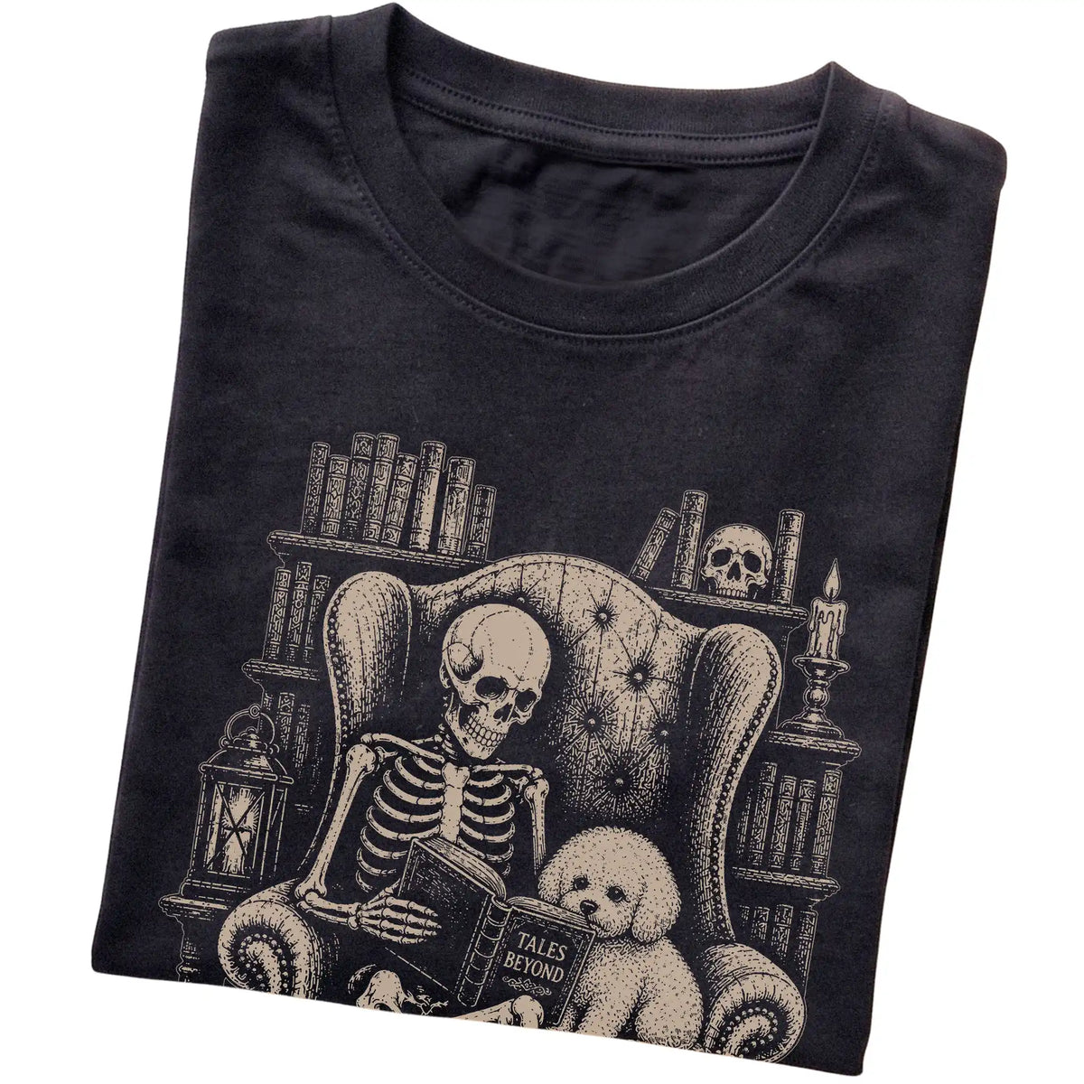 Folded Black T-shirt with a skeleton reading Tales Beyond to a Bichon Frise