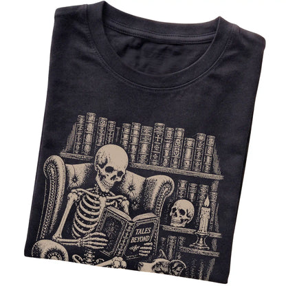 Folded Black T-shirt with a skeleton reading Tales Beyond to a Border Collie
