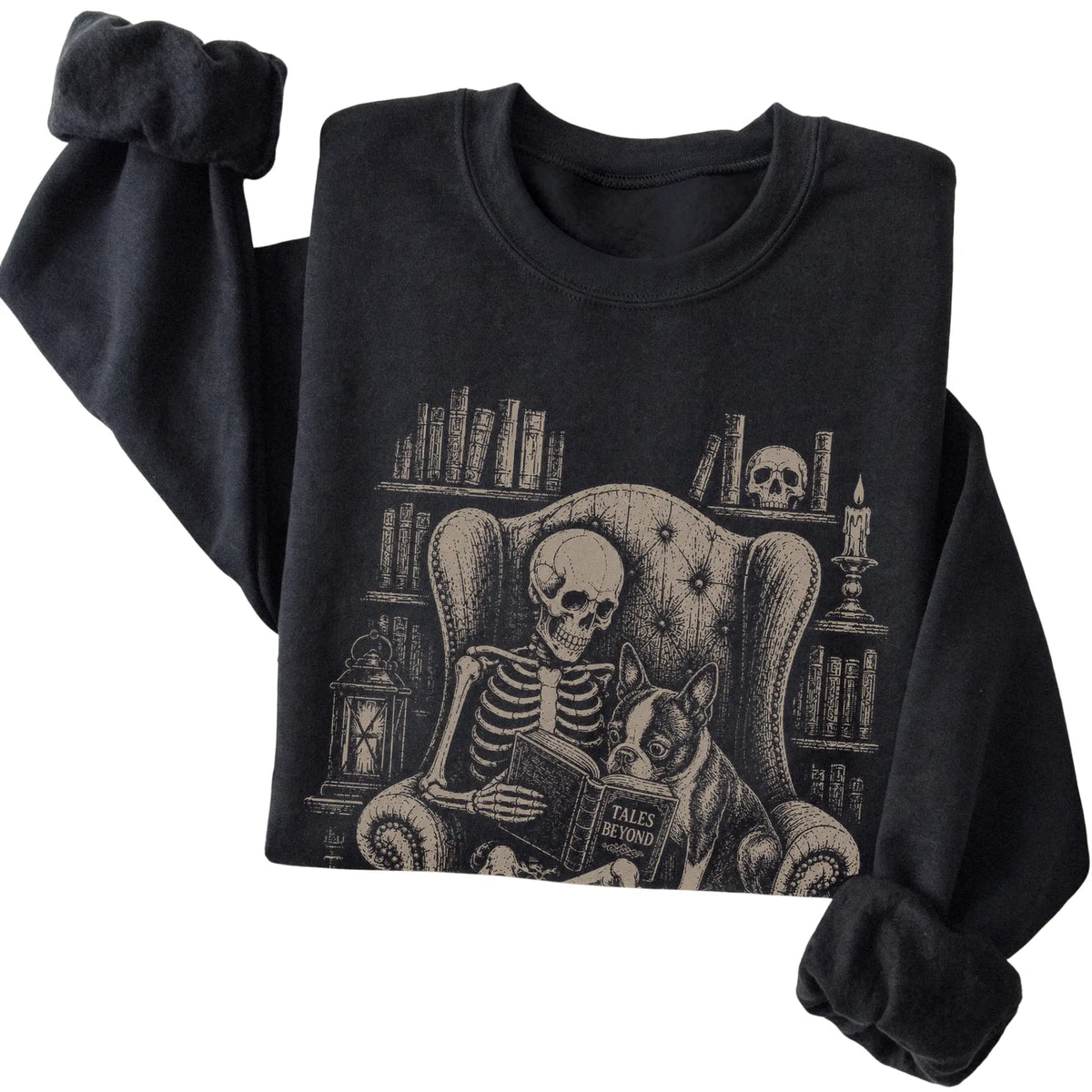 Folded Black sweatshirt with a skeleton reading Tales Beyond to a Boston Terrier