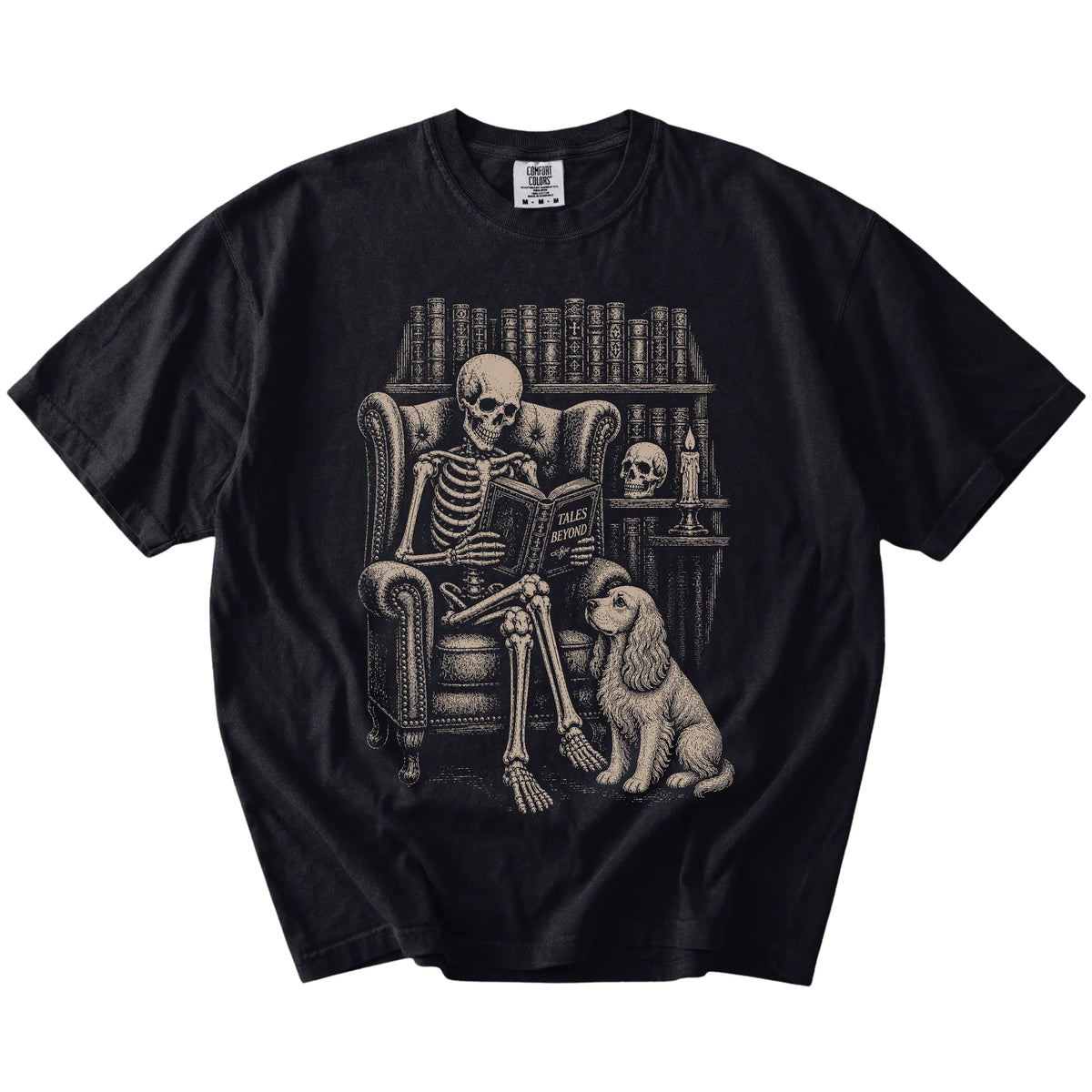 Skeleton reading in a library beside a Cocker Spaniel on a Black Comfort Colors® T-shirt